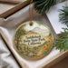 A decorative ornament with a scenic landscape of Saddleback State Park, California, featuring a mountain, trees, and a stream.