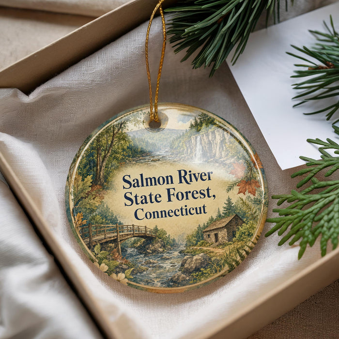 A decorative ornament with a scenic landscape of the Salmon River State Forest in Connecticut, featuring a bridge and pine trees.