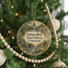 A Christmas tree decorated with ornaments, including a round ornament with a scenic image of the Salmon River State Forest in Connecticut.