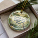 A decorative ornament in a box, featuring a scenic image of Sam Dale Lake, State Fish and Wildlife Area, Illinois.