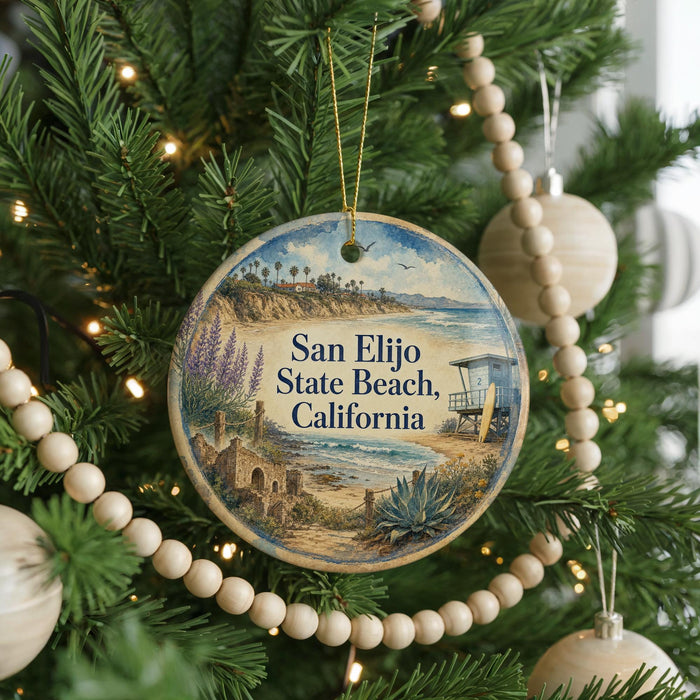 A round ornament hanging on a Christmas tree, featuring a beach scene with palm trees and a lifeguard tower.