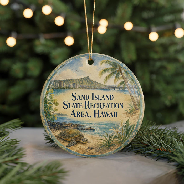 A round ornament with a beach scene and palm trees, featuring the text "Sand Island State Recreation Area, Hawaii" on it.