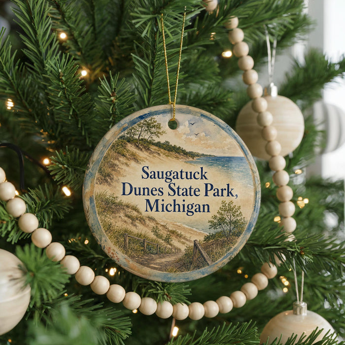A round ornament hanging on a Christmas tree, featuring a scenic image of a beach and dunes.