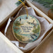 A decorative ornament in a white box, featuring a lighthouse, a bird, and a palm tree, with the text " Sebastian Inlet State Park, Florida" printed on it.