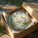 A decorative ornament in a box, featuring a lighthouse and a seagull, with the text " Sebastian Inlet State Park, Florida" printed on it.