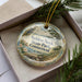 A decorative ornament in a box, featuring a scenic landscape with a bird and trees, along with the text "SELDEN NECK STATE PARK, CONNECTICUT".