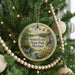 A round ornament hanging on a Christmas tree, featuring a scenic image of Seneca Creek State Park, Maryland.