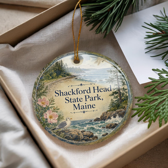 A round ornament with a scenic image of Shackford Head State Park, Maine, hanging from a string.