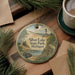 A round ornament featuring a scenic landscape of Silver Lake State Park, Michigan, with a lighthouse in the background.