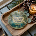 A decorative ornament featuring a manatee and the text "Silver Springs State Park, Florida" is displayed on a wooden tray, accompanied by pine cones and a lit candle.