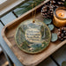 A wooden tray with a decorative ornament featuring a scenic landscape of Sinkhole Wilderness State Park, California, and pine cones.