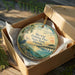 A decorative ornament in a box, featuring a seagull and a pier, with the text "Skyway Fishing Pier State Park, Florida" printed on it.