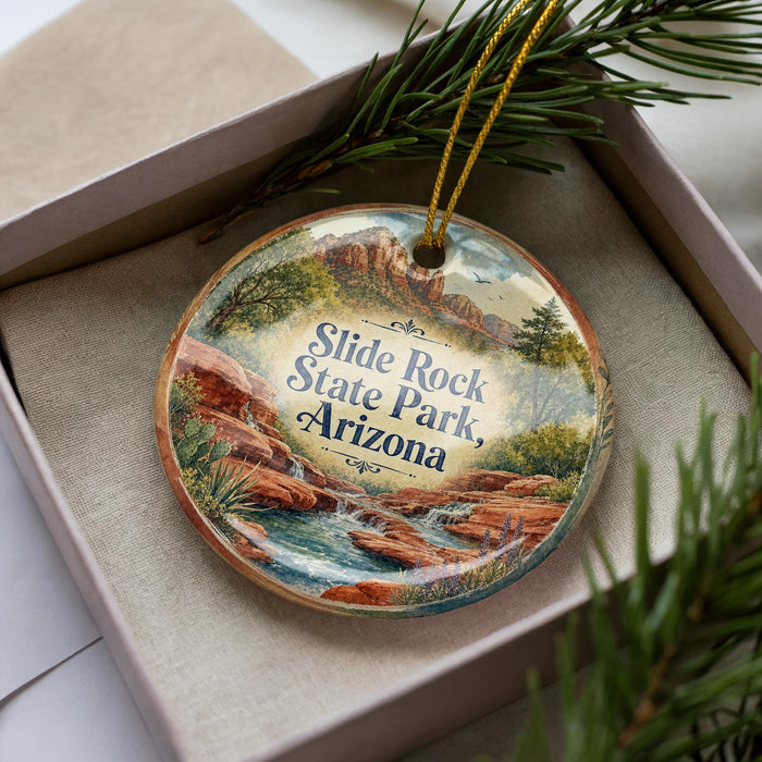 A decorative ornament with a scenic landscape of a river and mountains, featuring the text "Slide Rock State Park, Arizona" on it.