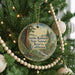 A round ornament hanging on a Christmas tree, featuring a scenic image of the Smithe Redwoods State Natural Reserve in California.