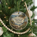 A round ornament hanging on a Christmas tree, featuring a scenic image of Sonoma Coast State Park, California.