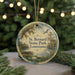 A circular ornament with a painting of St. Bernard State Park in Louisiana, featuring a bird, water lilies, and a dock.