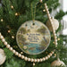 A round ornament hanging on a Christmas tree, featuring a lighthouse, palm trees, and a bird, with the text "St. Lucie Inlet Preserve State Park, Florida" displayed on it.
