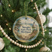 A round ornament hanging on a Christmas tree, featuring a scenic image of Straits State Park, Michigan.