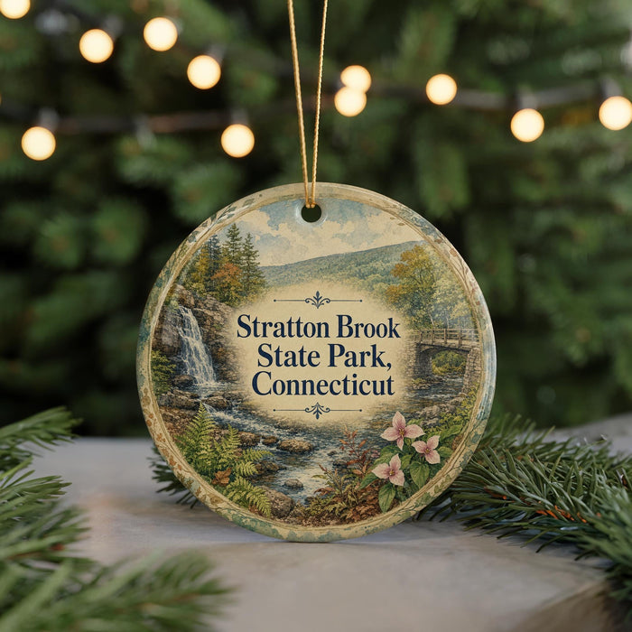 A round ornament with a scenic image of Stratton Brook State Park, Connecticut, featuring a waterfall and pine trees.