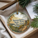 A decorative ornament with a scenic landscape of Susquehanna State Park, Maryland, hanging from a string.