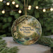 A decorative ornament featuring a scenic image of Suwannee River State Park in Florida, with a bird, flowers, and a boat in the water.