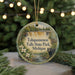 A round ornament with a painting of Tahquamenon Falls State Park, Michigan, featuring a black bear and a waterfall.