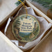 A decorative ornament in a box, featuring a scenic landscape with a tower and trees, with the text "Talcott Mountain State Park, Connecticut" printed on it.