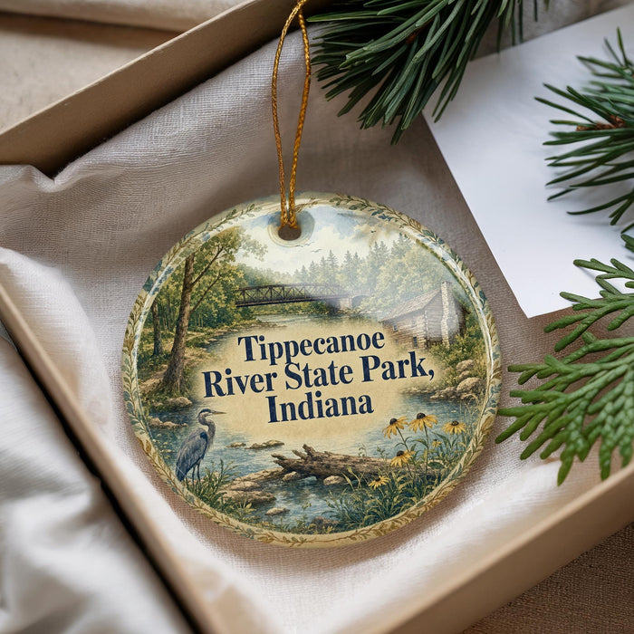 A decorative ornament with a scenic image of Tippecanoe River State Park, Indiana, hanging from a string.