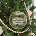 A round ornament hanging on a Christmas tree, featuring a scenic image of Tippecanoe River State Park, Indiana.