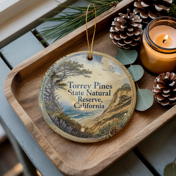 A wooden tray with a decorative ornament featuring a scenic landscape of Torrey Pines State Natural Reserve, California, and pine cones.