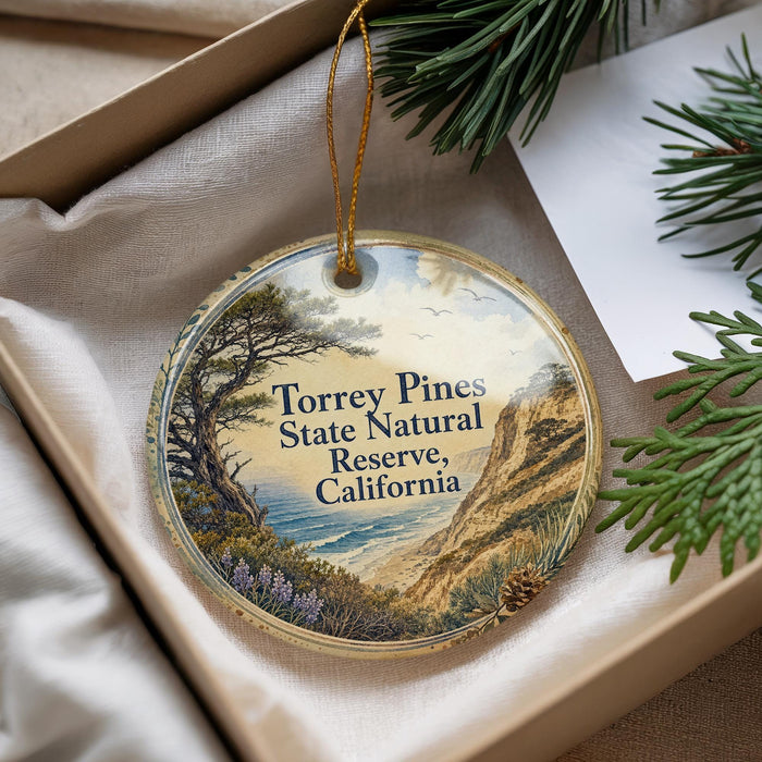 A round ornament with a scenic landscape of Torrey Pines State Natural Reserve, California, hanging from a string.