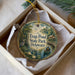 A round ornament with a painting of a pond and a bird, along with the text " Trap Pond State Park, Delaware".