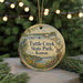 A round ornament with a scenic image of Tuttle Creek State Park, Kansas, featuring a bird, a deer, and a boat on the water.