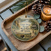 A wooden tray with a decorative ornament featuring a scenic landscape of Upper Sioux Agency Park, Minnesota, and pine cones.