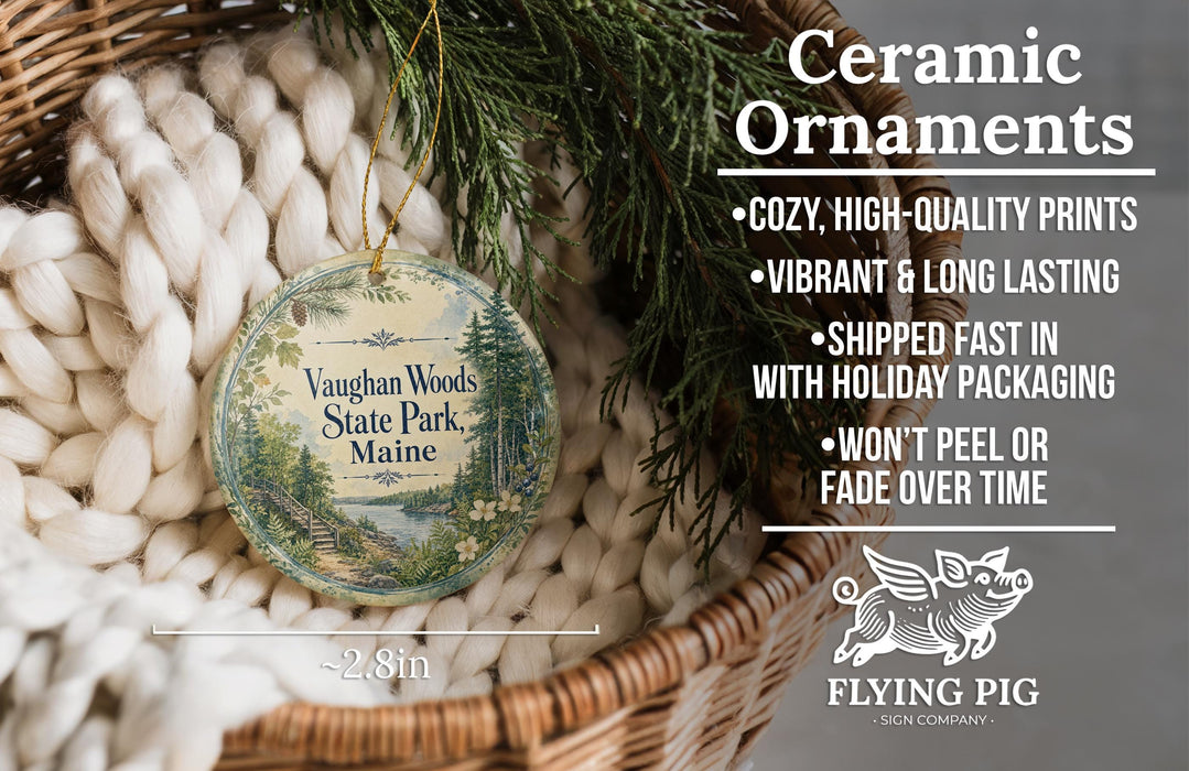 Ceramic ornaments, specifically a round ornament with a scenic design, are displayed in a basket with greenery. The ornament is described as cozy, high-quality prints, vibrant, and long lasting, and it is shipped fast in holiday packaging. The ornament is not peeling or fading over time.