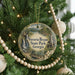 A round ornament hanging on a Christmas tree, featuring a scenic image of Victoria Bryant State Park in Georgia.