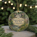 A circular ornament with a scenic image of Wadsworth Falls, State Park, Connecticut, surrounded by greenery and a string of lights.