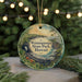 A circular ornament with a scenic image of Waianapapa State Park, Hawaii, featuring a tropical landscape with palm trees, a beach, and a waterfall.
