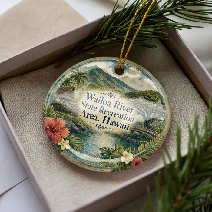 A decorative ornament with a tropical island landscape, featuring palm trees, flowers, and a body of water, is displayed in a box.
