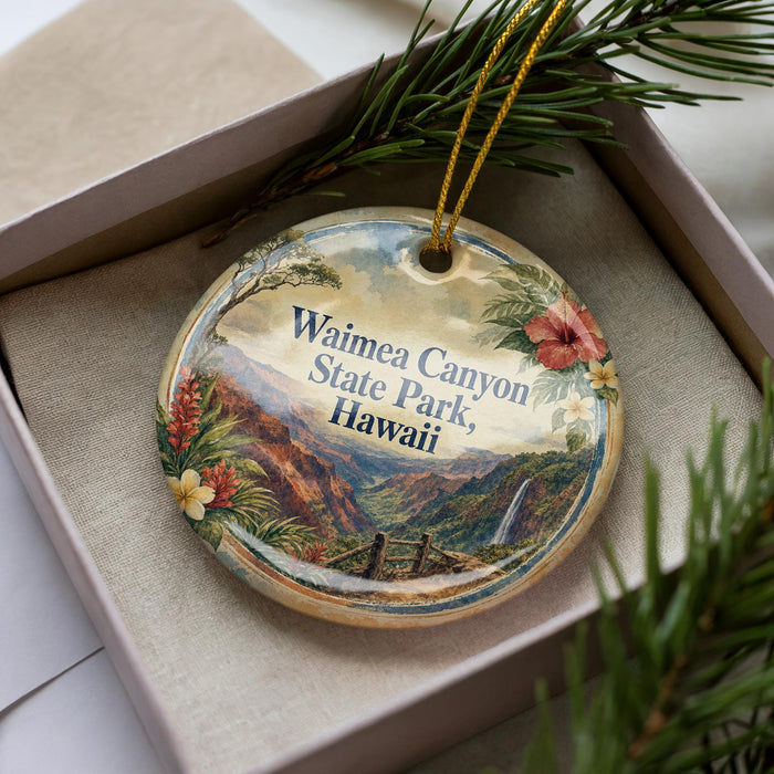 A decorative ornament in a box, featuring a scenic image of Waimea Canyon State Park in Hawaii.