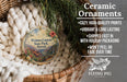 Ceramic ornaments, featuring a round ornament with a tropical landscape design, are displayed in a woven basket.