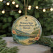A circular ornament featuring a tropical beach scene with a pier, palm trees, and a turtle, hanging from a string.