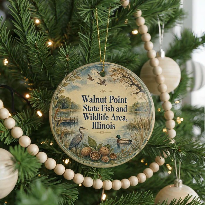 A round ornament hanging on a Christmas tree, featuring a scenic image of walnuts, ducks, and a lake.