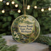 A circular ornament with a scenic image of Warren Woods State Park, Michigan, featuring a forest, a stream, and white flowers.