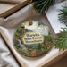 A round ornament with a scenic forest landscape, featuring a waterfall, pine trees, and a sign indicating the Warwick State Forest in Massachusetts.