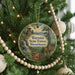 A round ornament on a Christmas tree, featuring a scenic image of the Warwick State Forest in Massachusetts.