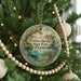 A round ornament hanging on a Christmas tree, featuring a scenic image of Wekiva Springs State Park in Florida.
