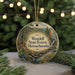 A round ornament with a scenic forest landscape and text that reads "Wendell State Forest, Massachusetts" is displayed against a blurred background of Christmas lights.