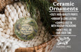 Ceramic ornaments, featuring a detailed illustration of a bird and a tree, are displayed in a woven basket. The text highlights the ornaments as "Ceramic Ornaments" and mentions their features such as "COZY, HIGH-QUALITY PRINTS", "VIBANT & LONG LASTING", "SHIPPED FAST IN WITH HOLIDAY PACKAGING", and "WON'T EEL OR FADE OVER TIME". The image also includes a scale for the ornaments and a logo for "FLYING PIG - SIGN COMPANY".