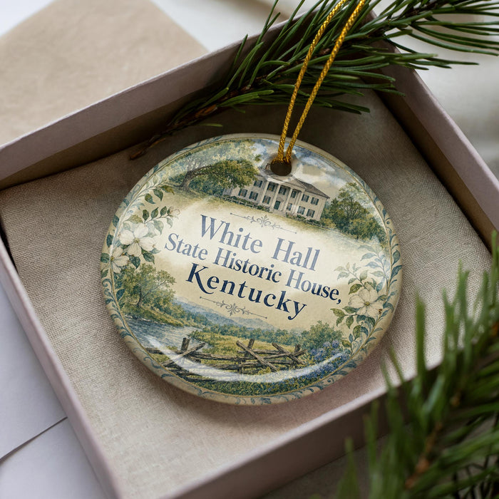 A decorative ornament in a box, featuring a house and trees, with the text "White Hall State Historic House, Kentucky" printed on it.